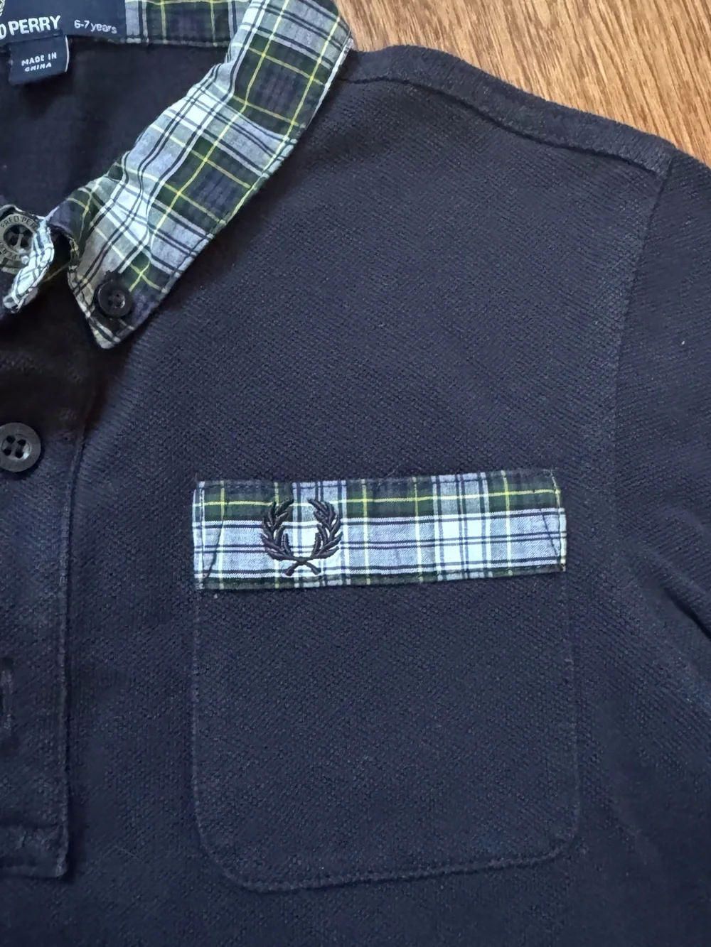 Fred Perry black polo shirt with plaid collar and sleeve cuffs, size 6-7 years